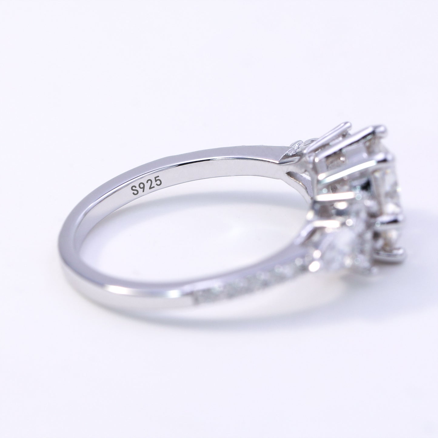 Silver ring with a diamond on a white background